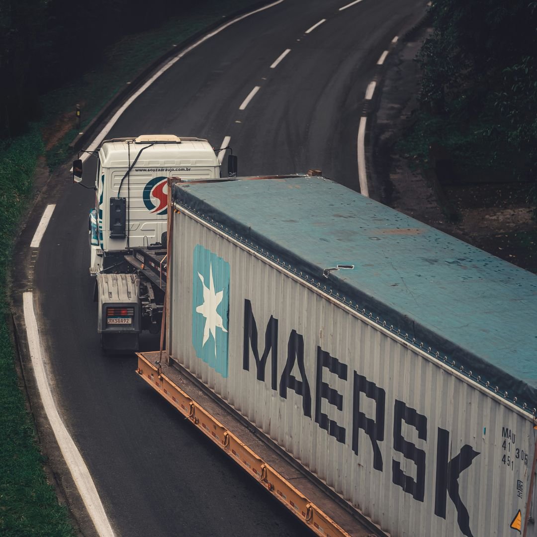 Aerial view of a truck on a forest highway with tracking data