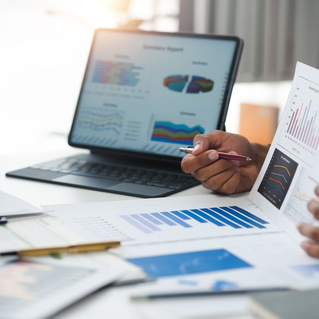 Compliance reports and charts on a laptop